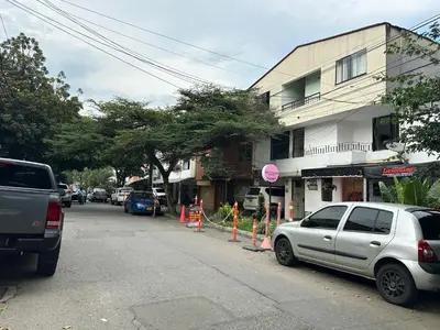 a street with cars parked on the side of a building at loft dreams 7006 in Medellín