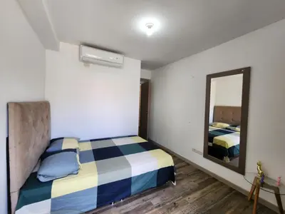 a small bedroom with a bed and a mirror at Family Resort Santa Fe De Antioquia - Santa Fe de Antioquia in Santa Fe de Antioquia