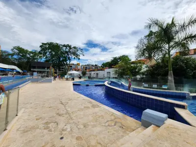 a pool at a resort with blue water at Family Resort Santa Fe De Antioquia - Santa Fe de Antioquia in Santa Fe de Antioquia