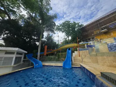 a swimming pool with a slide in a playground at Family Resort Santa Fe De Antioquia - Santa Fe de Antioquia in Santa Fe de Antioquia