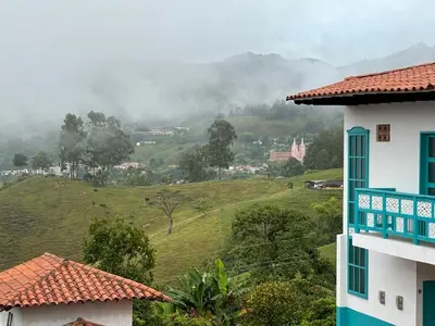 a view of a green hillside with a building at La Casa del Colibrí in Jericó