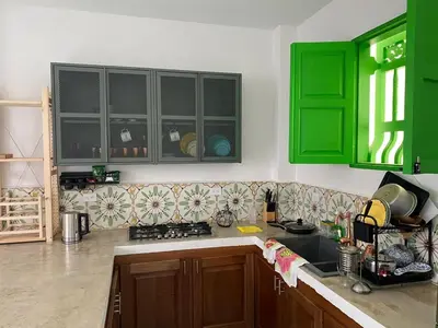 a kitchen with green cabinets and a sink at La Casa del Colibrí in Jericó