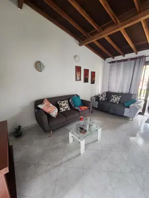 a living room with two couches and a table at comoda habitacion con baño compartido in Itagüí