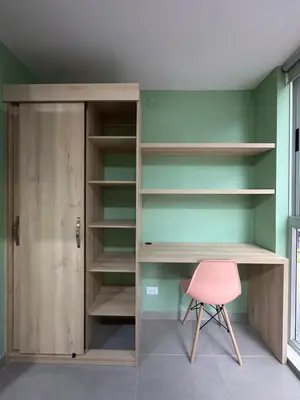 a room with a desk and a pink chair at Amaranto Suites in Medellín