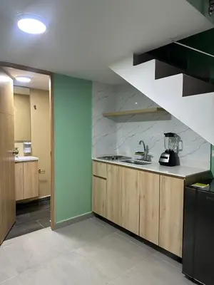 a kitchen with a sink and a staircase at Amaranto Suites in Medellín
