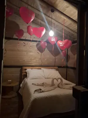 a room with a bed with valentines hearts on the wall at Alma Cabañas y Spa in Guarne