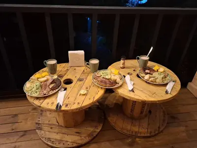 two wooden tables with plates of food on them at Alma Cabañas y Spa in Guarne