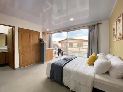 a bedroom with a large bed and a large window at Horus Loft - Con Terraza en todo el Centro in Carmen de Viboral