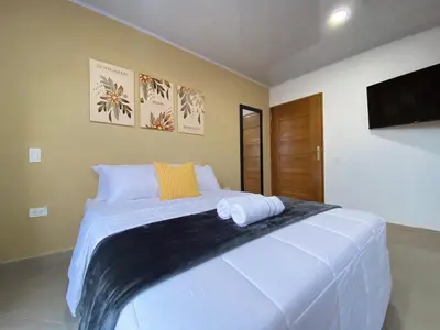 a bedroom with a large white bed with two pillows at Horus Loft - Con Terraza en todo el Centro in Carmen de Viboral