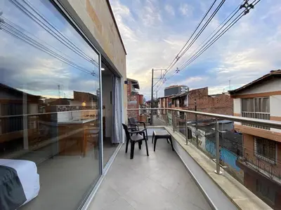 a balcony with a table and chairs on a building at Horus Loft - Con Terraza en todo el Centro in Carmen de Viboral