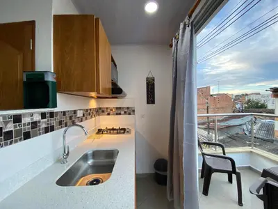 a kitchen with a sink and a window with a view at Horus Loft - Con Terraza en todo el Centro in Carmen de Viboral