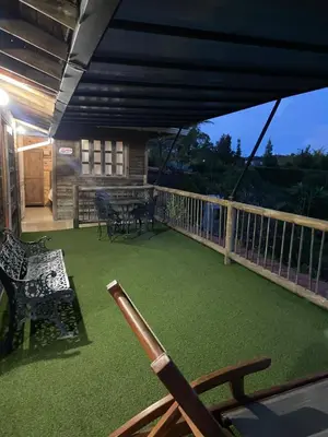 a baseball bat on a deck with a table and chairs at Loge Cabaña peñol-Guatape in El Peñol