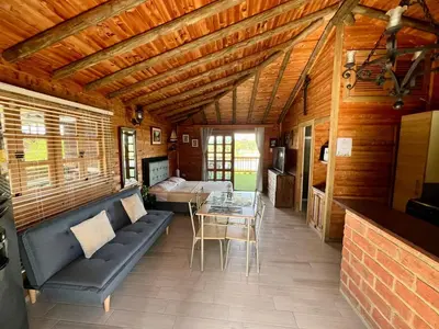 a living room with a couch and a table at Loge Cabaña peñol-Guatape in El Peñol