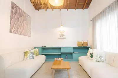 a living room with two white couches and a table at Chill-Out | Jacuzzi todo el año | Unicentro 5 minu in Medellín