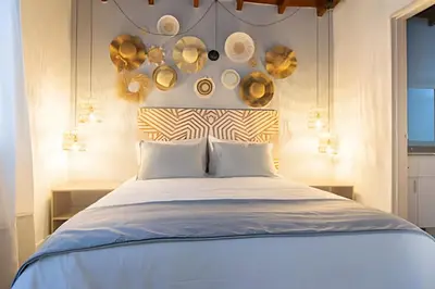 a bedroom with a large bed with gold accents at Chill-Out | Jacuzzi todo el año | Unicentro 5 minu in Medellín