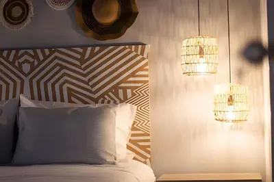 a bedroom with a bed and two chandeliers at Chill-Out | Jacuzzi todo el año | Unicentro 5 minu in Medellín