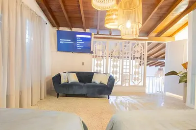 a living room with a blue couch and a tv at Chill-Out | Jacuzzi todo el año | Unicentro 5 minu in Medellín