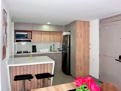 a kitchen with a counter and a black refrigerator at 3BR Family & Corporate Friendly El Poblado in Medellín
