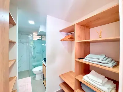 a bathroom with wooden shelves and a toilet at 3BR Family & Corporate Friendly El Poblado in Medellín