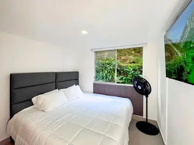a bedroom with a white bed and a window at 3BR Family & Corporate Friendly El Poblado in Medellín
