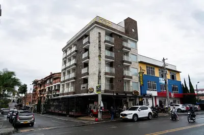a tall building on a city street with cars at Hotel Las Vegas in Rionegro