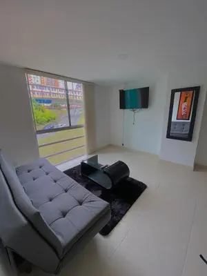 a living room with a couch and a table at Apartamento Urban Manizales in Manizales