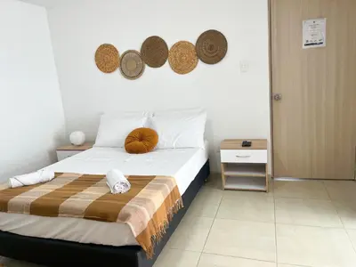 a bedroom with a bed with hats on the wall at Loft dreams 7005 in Medellín