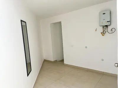 a white room with a door and a mirror at Loft dreams 7005 in Medellín