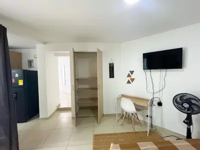 a living room with a desk and a tv on a wall at Loft dreams 7005 in Medellín