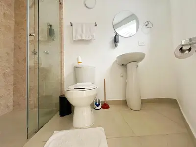 a bathroom with a toilet and a shower and a mirror at Loft dreams 7005 in Medellín