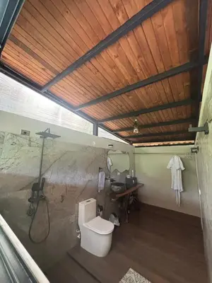 a bathroom with a toilet and a sink in a room at Cabaña Montecielo San Rafael in San Rafael