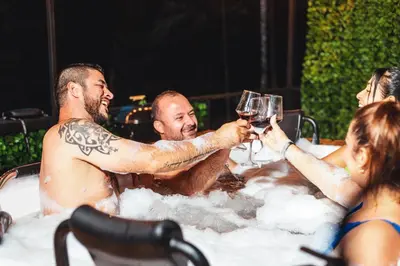 a group of people drinking wine in a hot tub at Cabaña Montecielo San Rafael in San Rafael