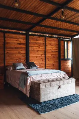 a bed in a room with a wooden ceiling at Cabaña Montecielo San Rafael in San Rafael
