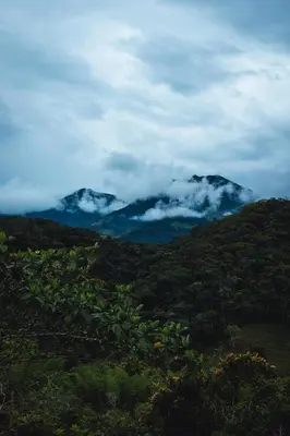 a view of a mountain range with clouds and trees at Cabaña Montecielo San Rafael in San Rafael