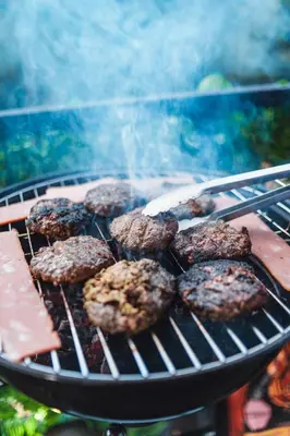 a bunch of hamburgers cooking on a grill at Cabaña Montecielo San Rafael in San Rafael