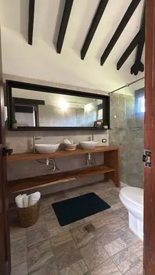 a bathroom with two sinks and a tub and a toilet at Finca en Sopetran in Sopetran