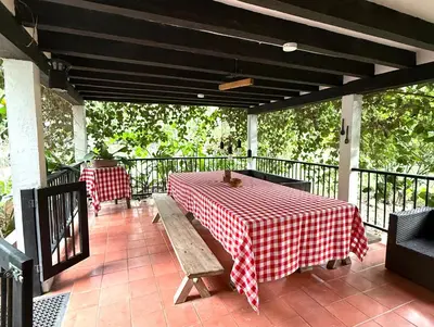 a red and white checkered table and bench on a porch at Finca en Sopetran in Sopetran