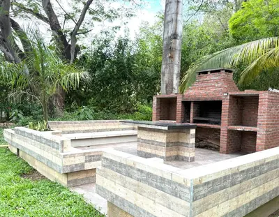 a brick fireplace on a patio in a garden at Finca en Sopetran in Sopetran