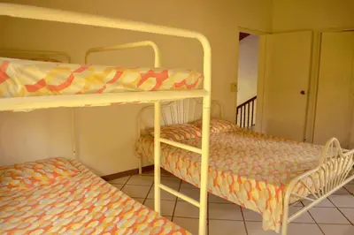a bedroom with two bunk beds and a staircase at Villa Privada con entrada y salida 100 por ciento flexible in La Florida