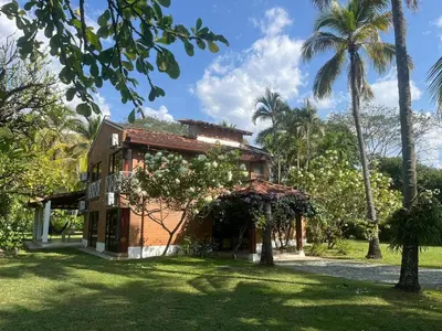 a house with palm trees in front of it at Villa Privada con entrada y salida 100 por ciento flexible in La Florida