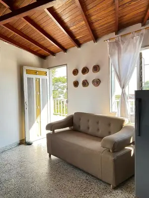 a living room with a couch and a window at Medellin Apartamento con hermosa vista in Medellín