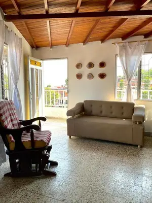 a living room with a couch and a chair at Medellin Apartamento con hermosa vista in Medellín