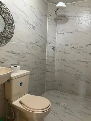 a bathroom with a toilet and a sink and a shower at Medellin Apartamento con hermosa vista in Medellín