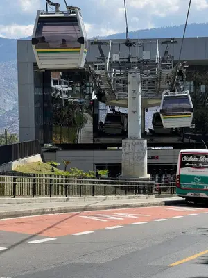 a bus driving down a street with a gondola at Medellin Apartamento con hermosa vista in Medellín