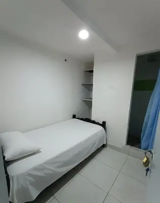 a white bedroom with a bed and a window at Corazón Verde in Itagüí