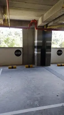 an empty parking lot with signs on the side of a building at Brand New Apartment Manizales in Manizales