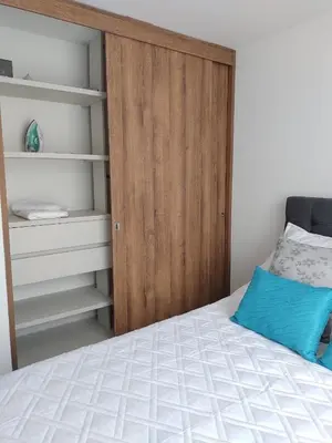 a bedroom with a bed and a wooden door at Brand New Apartment Manizales in Manizales
