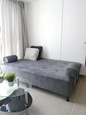 a bed in a room with a glass table at Brand New Apartment Manizales in Manizales