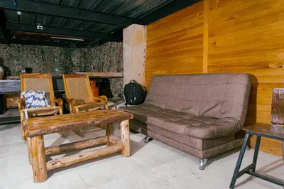 a living room with a couch and two chairs at Cabaña sol in Medellín