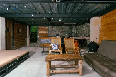 a patio with a couch and chairs and a table at Cabaña sol in Medellín